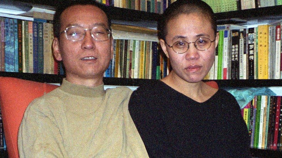 Liu Xiaobo and Liu Xia in front of a full bookcase