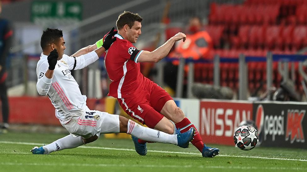 james Milner of Liverpool is fouled by Casemiro of Real Madrid during the UEFA Champions League Quarter Final Second Leg match between Liverpool FC and Real Madrid at Anfield on April 14, 2021