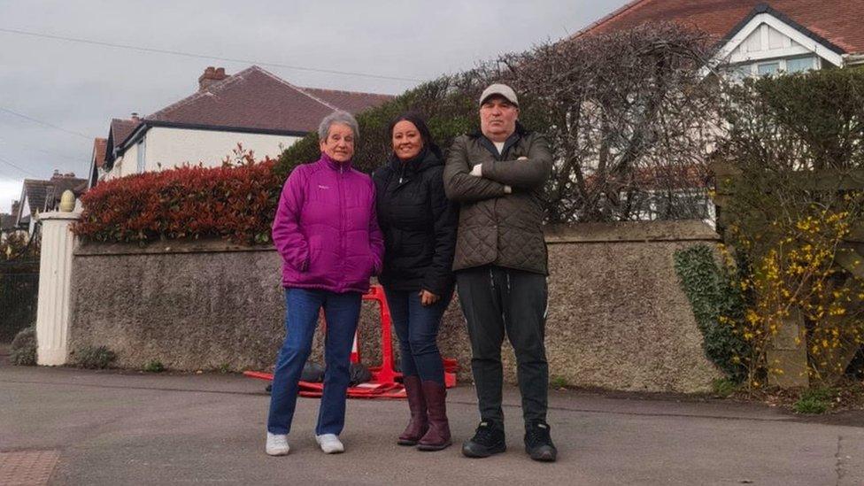 Mary West, Jenny Ashford and Clive Ashford outside their homes