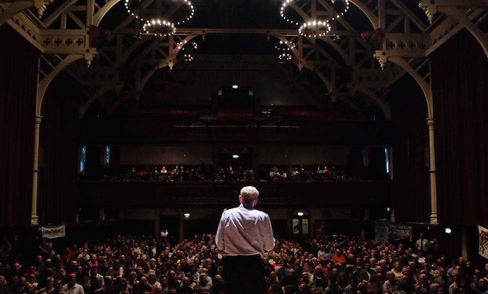 Jeremy Corbyn before audience in large hall