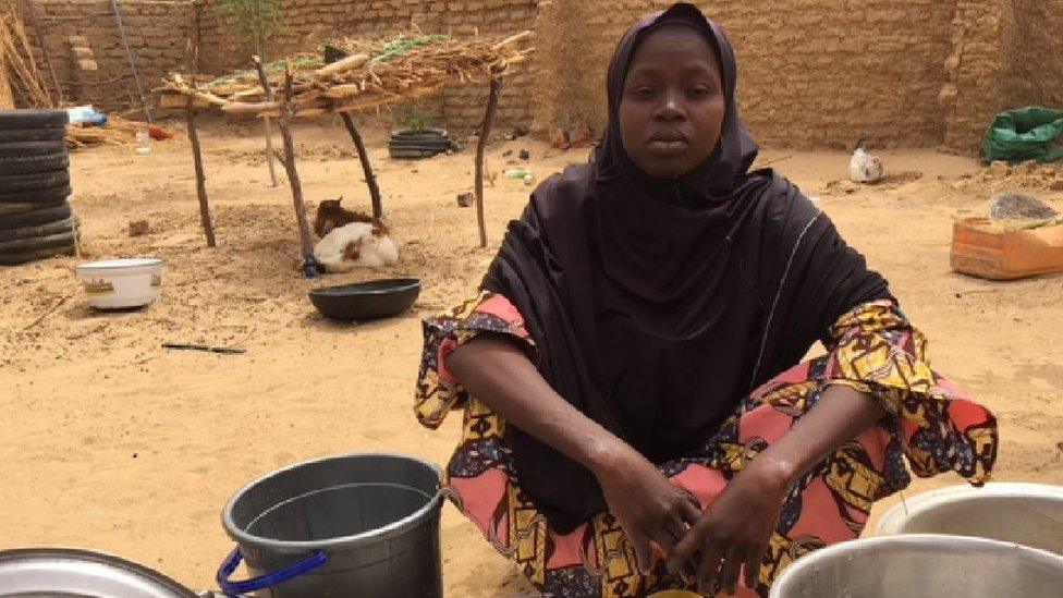 Falmata sitting washing dishes