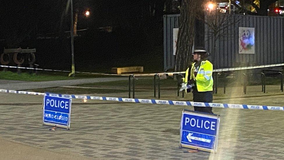 Police officer guarding cordon