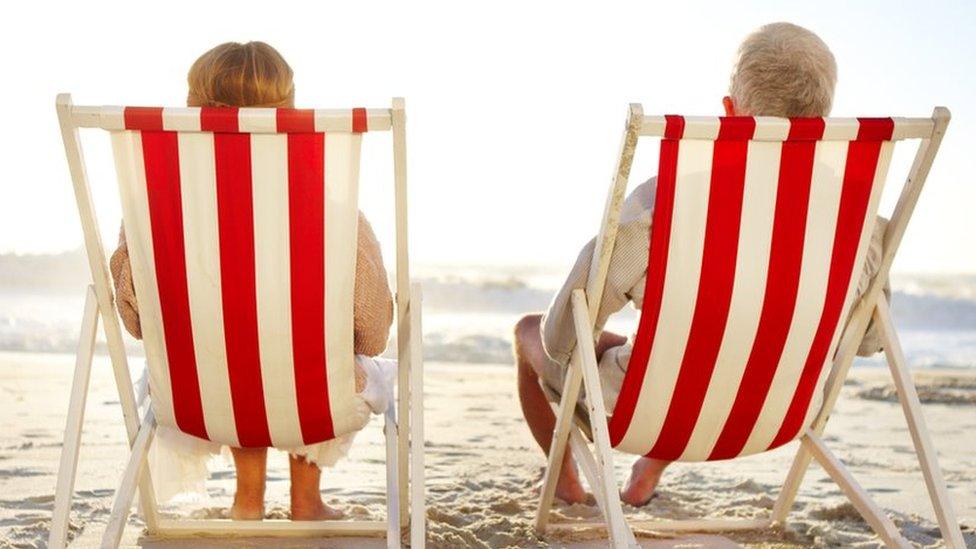 Retired couple sitting in deckchairs