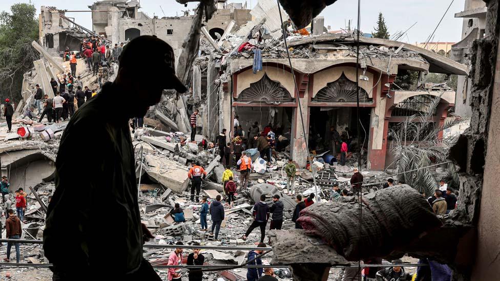 People search for survivors following Israeli bombardment on Rafah, in the southern Gaza Strip on 22 November 2023