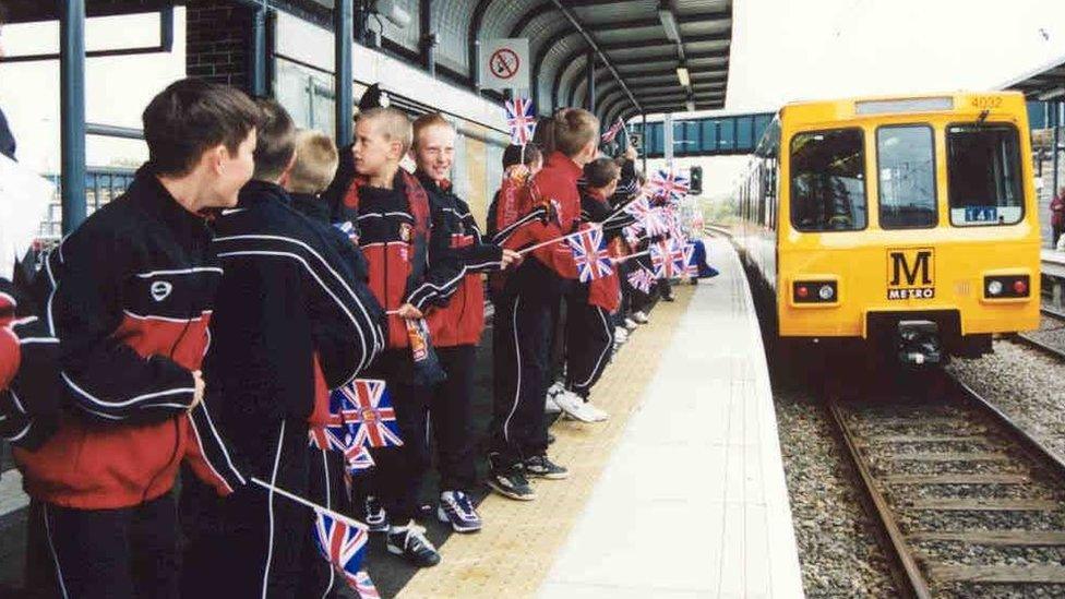 Schoolchildren waving flags