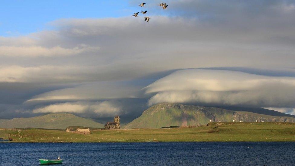 Clouds taking on the shape of mountains