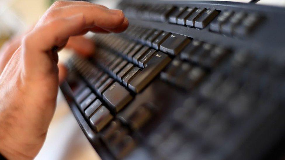 an employee typing on a computer keyboard at the headquarters of Internet security giant Kaspersky in Moscow