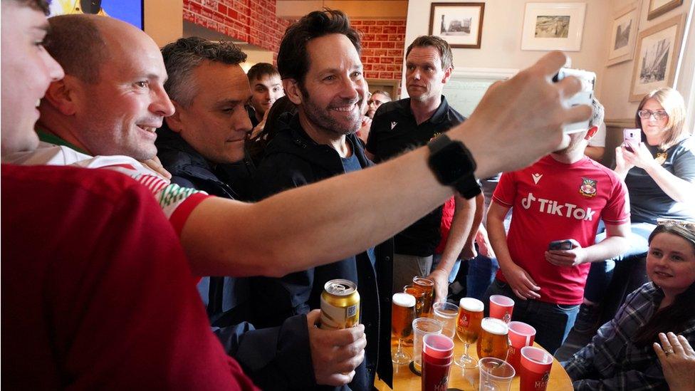 Hollywood actor Paul Rudd with Wrexham fans in the Turf pub