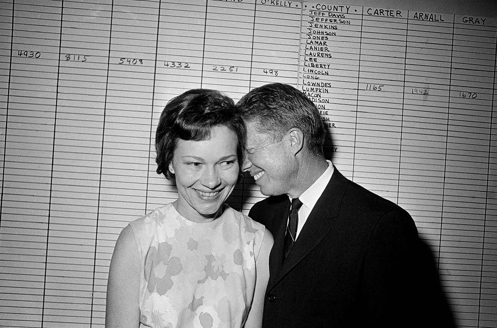 In this Sept. 15, 1966 file photo, then Georgia State Sen. Jimmy Carter hugs his wife, Rosalynn, at his Atlanta campaign headquarters.