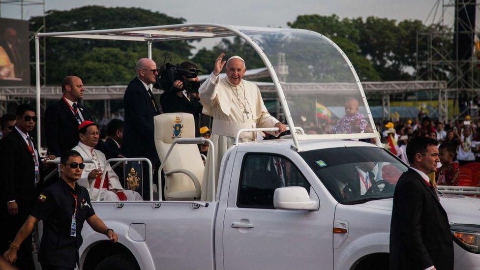 Pope Francis gets into a vehicle upon his arrival at Yangon International Airport