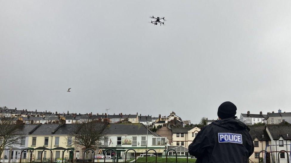 A UK police officer launches a drone. File photo