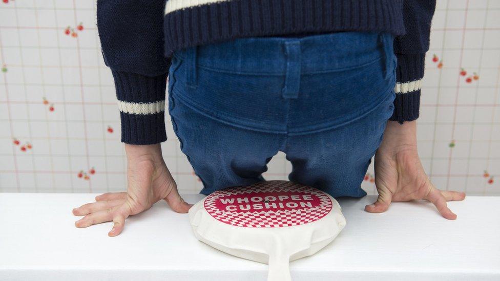 A whoopee cushion being sat on by a boy