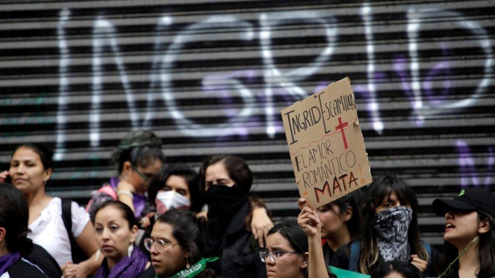 A demonstrator holds up a placard