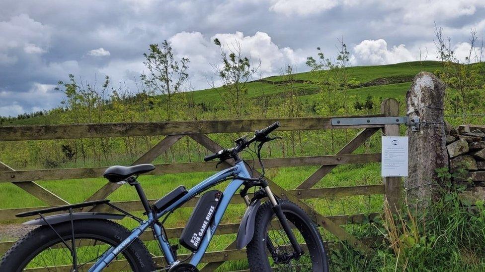 Bike propped up against gate