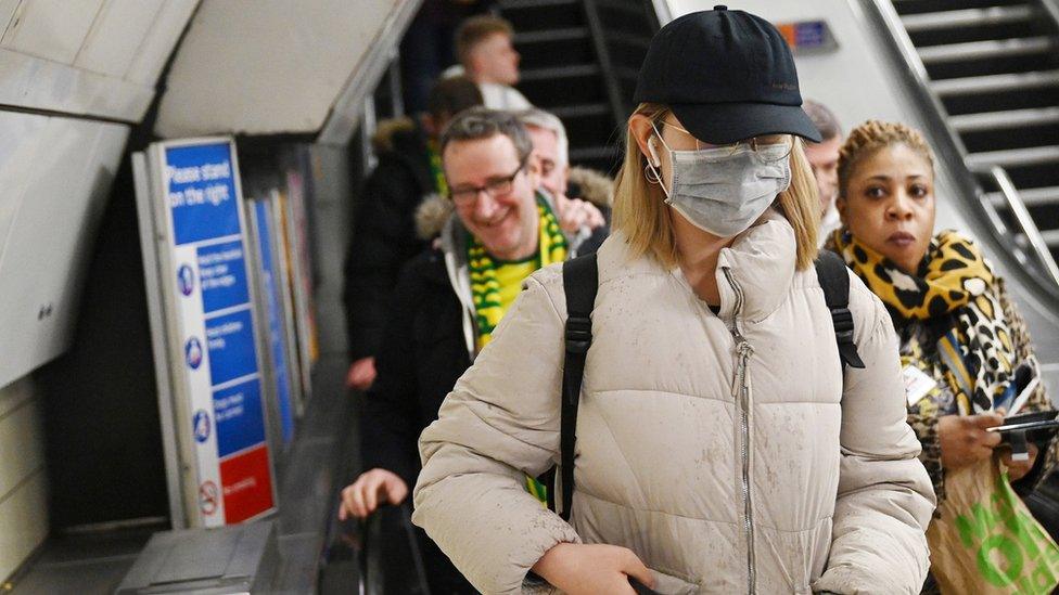 A woman in a mask on the tube