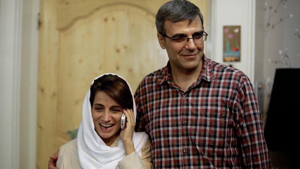 Nasrin Sotoudeh (L) speaks on the phone next to her husband Reza Khandan in 2013