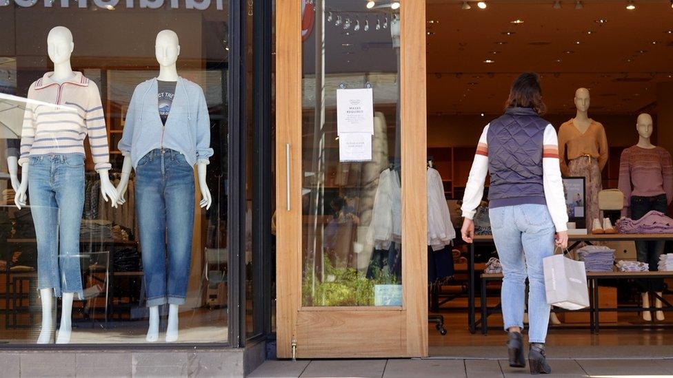 A shopper enters a J Crew store