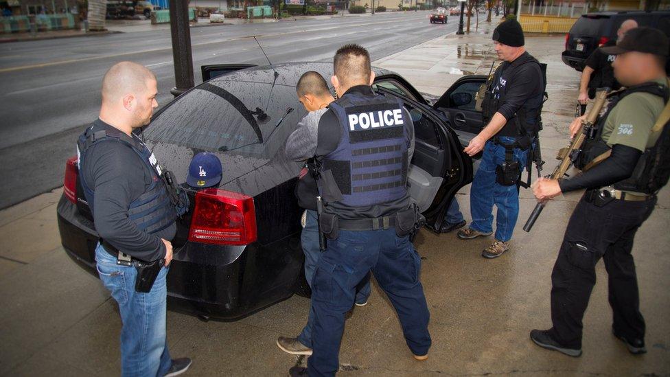 US Immigration officers detain a suspect in Los Angeles, California, 7/2/17