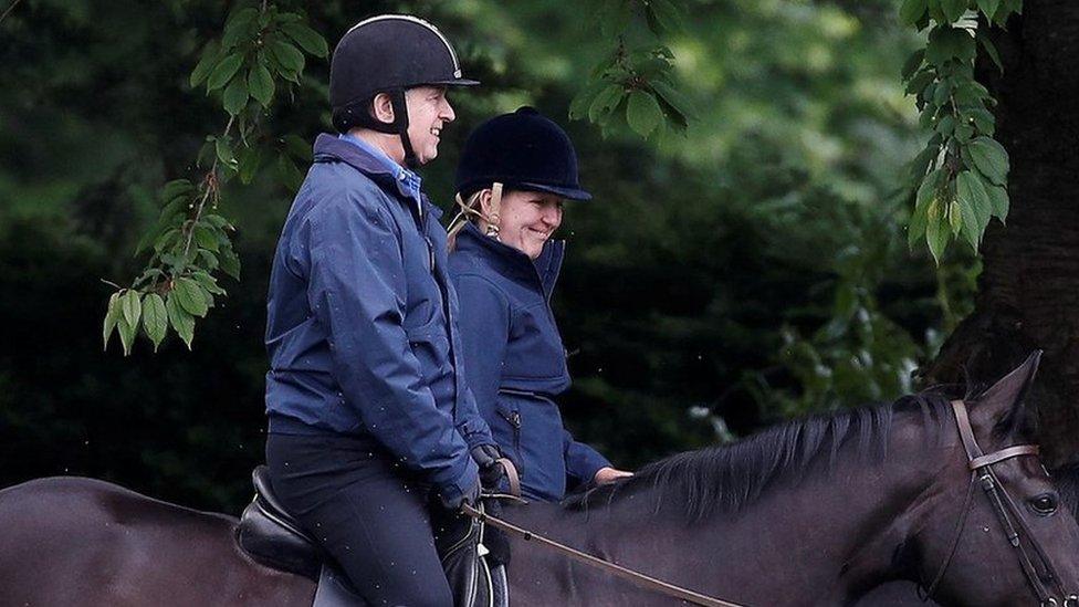 Prince Andrew riding a horse alongside another woman