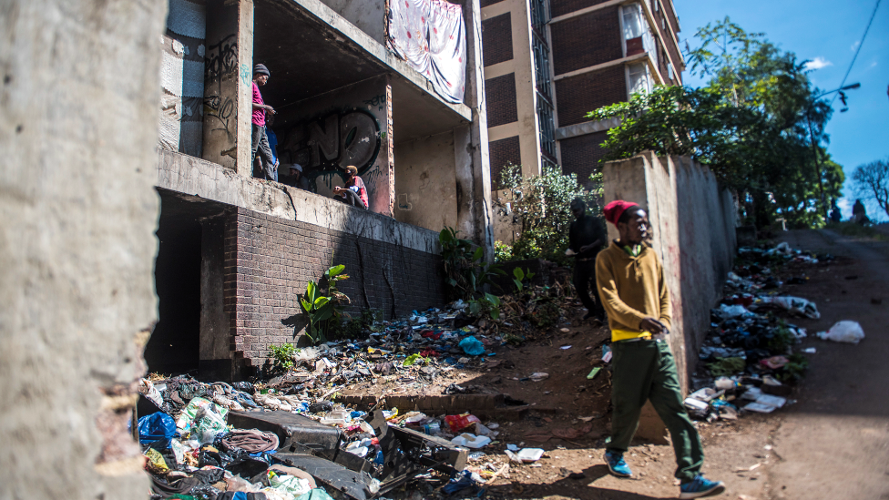 An unidentified man is seen leaving the San Jose the derelict San Jose building in Johannesburg, South Africa