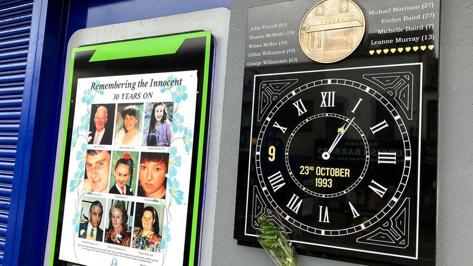 The Shankill bomb memorial consisting of a clock with its hands stopped at the time of the explosion and a plaque featuring images of the victims