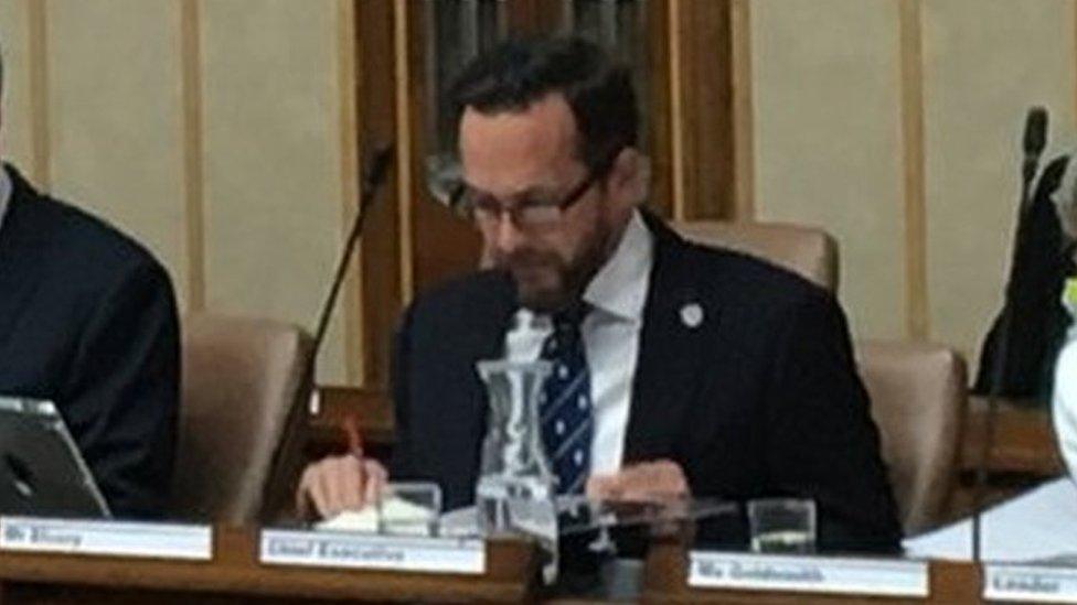 Nathan Elvery sits next to council leader Louise Goldsmith at a full council meeting in July 2019