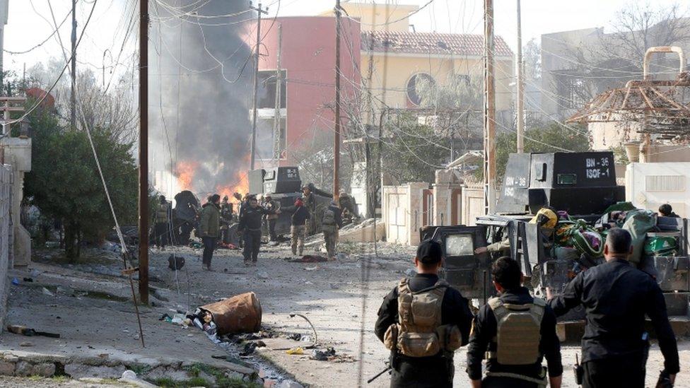 Iraqi Special Operations Forces (ISOF) stand guard after a car bomb exploded during an operation to clear the al-Andalus district of Islamic State militants, in Mosul, Iraq, January 16, 2017