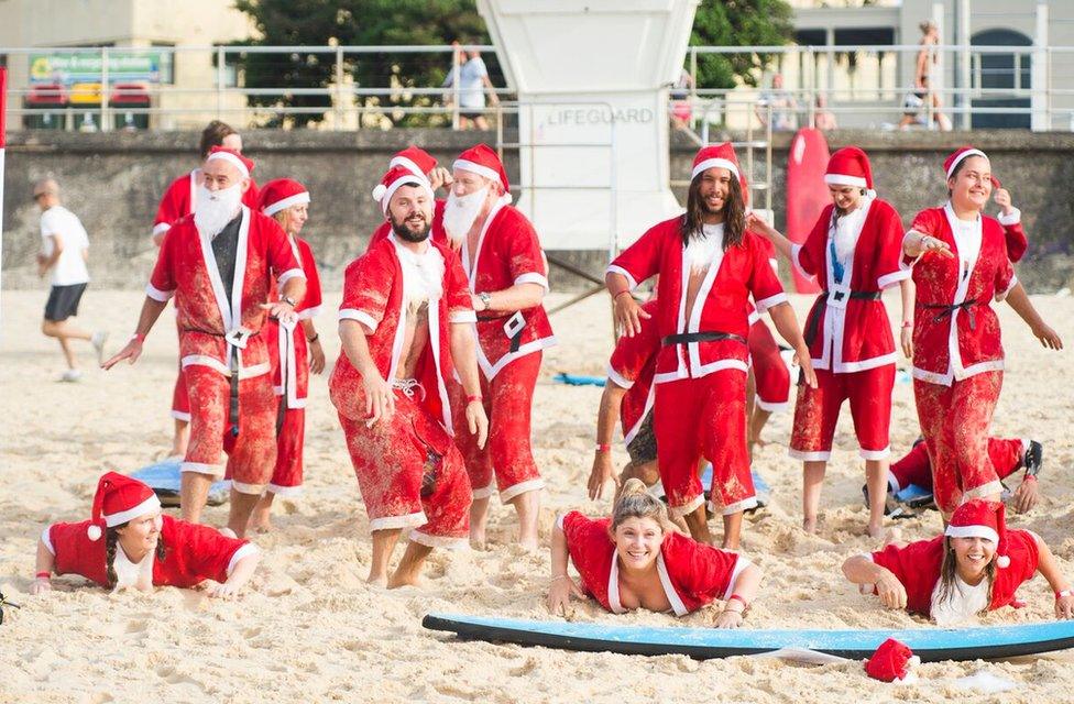 A pack of 320 surfing Santas embrace the Christmas spirit in Australia, breaking the Guinness World Record for the largest surf lesson.