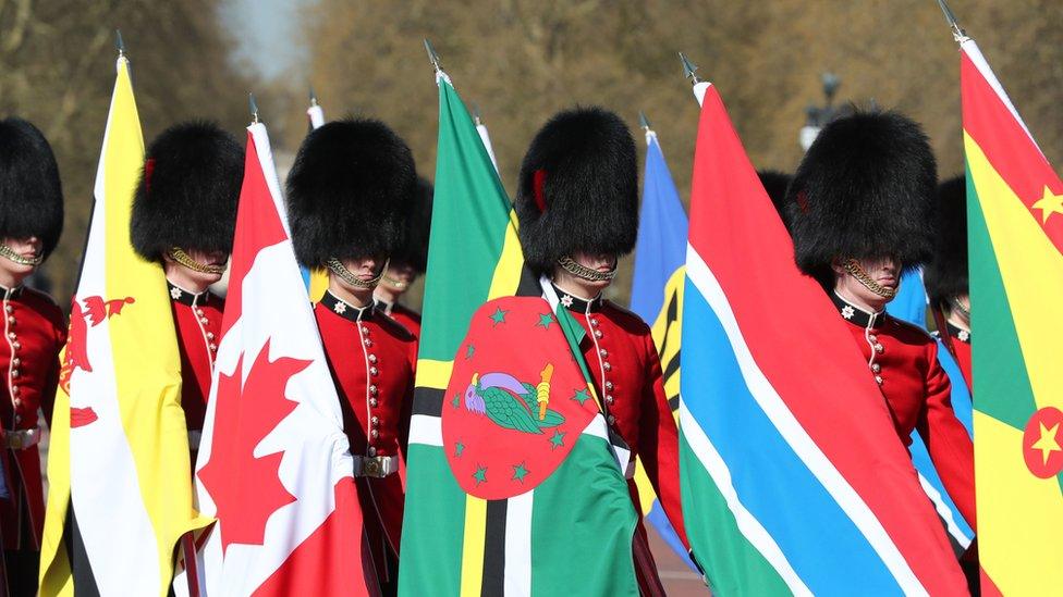 Soldiers of the Coldstream Guards carry flags of the 53 Commonwealth countries