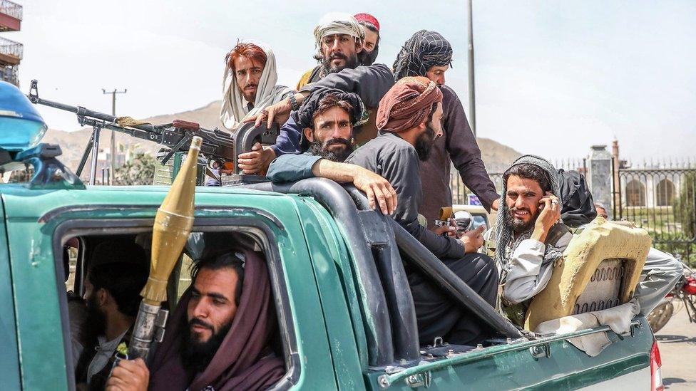 Taliban fighters are seen on the back of a vehicle in Kabul, Afghanistan, 16 August 2021