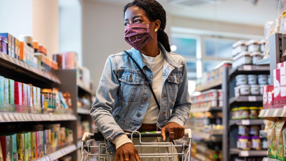 A woman shopping in a mask