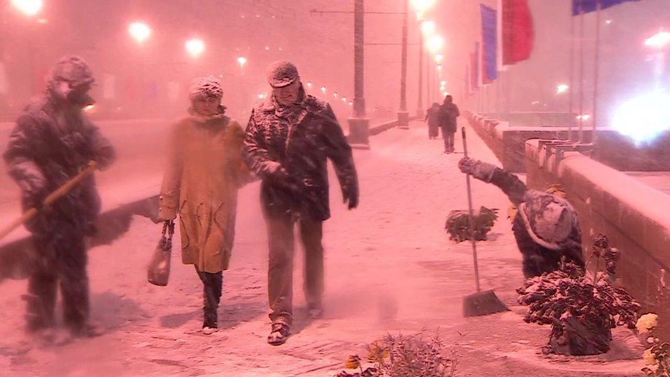 Guards look over a shrine for Boris Nemtsov