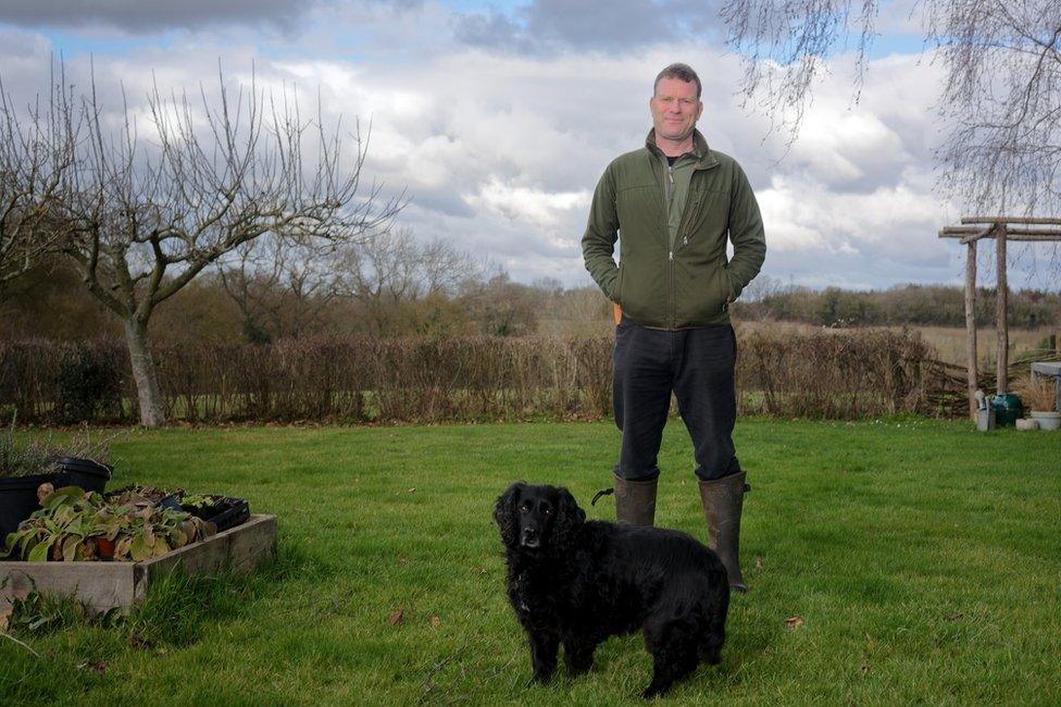 Paul Gwynne at home with his dog Barclay