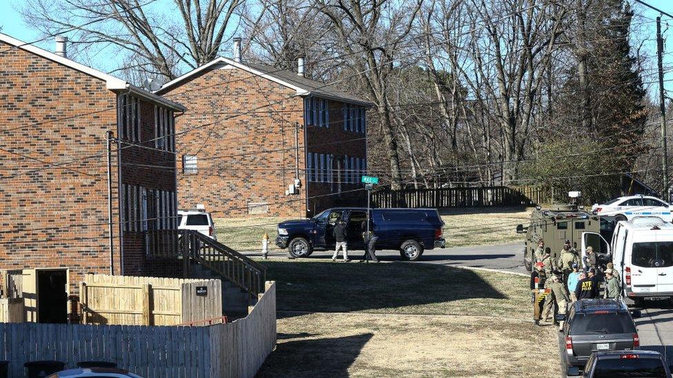 Law enforcement officers investigate the house belonging to Anthony Quinn Warner