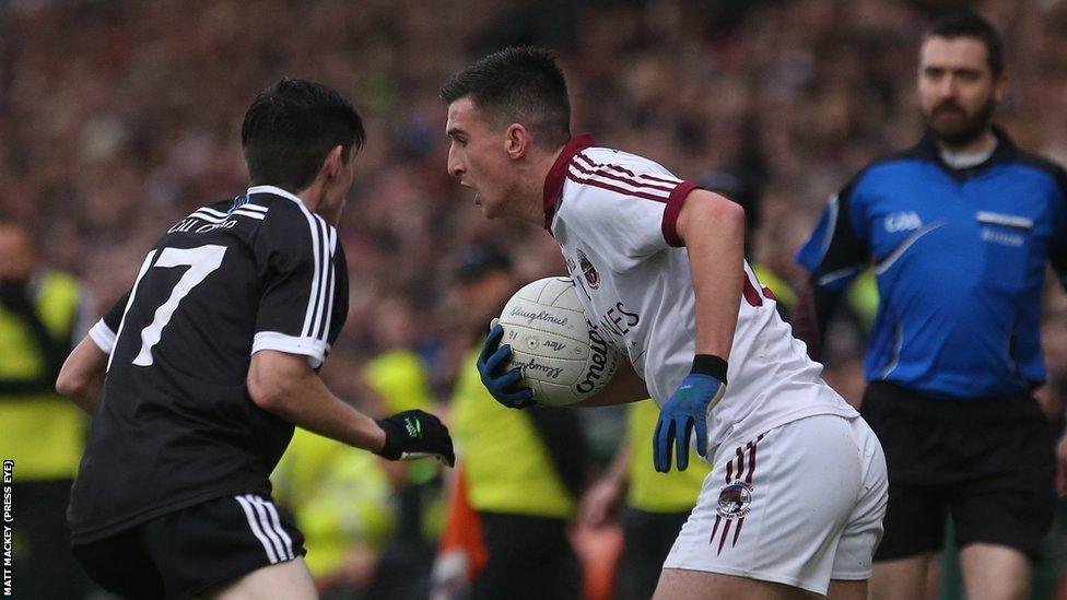 Kilcoo's Eugene Branagan attempts to block the progress of Slaughtneil opponent Meehaul McGrath during the Ulster Club decider