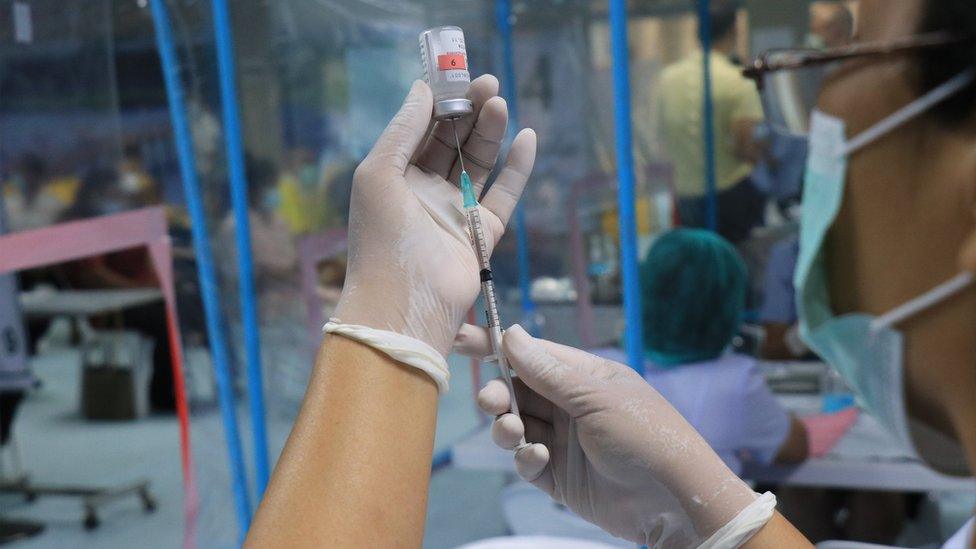 Syringe with vaccine in lab