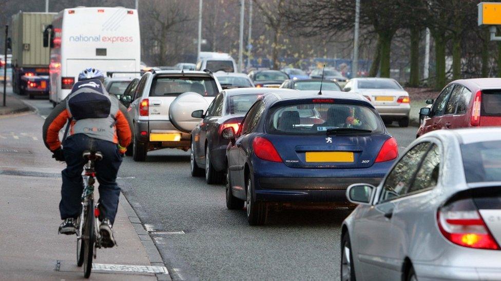 Early morning traffic builds up along the Princess Parkway into Manchester city centre.