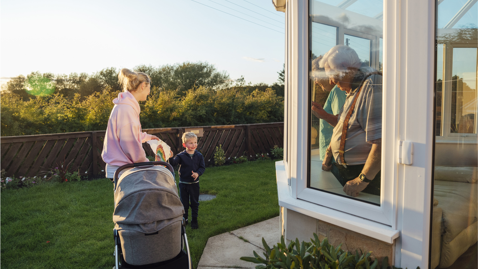 Older people meeting younger people through window