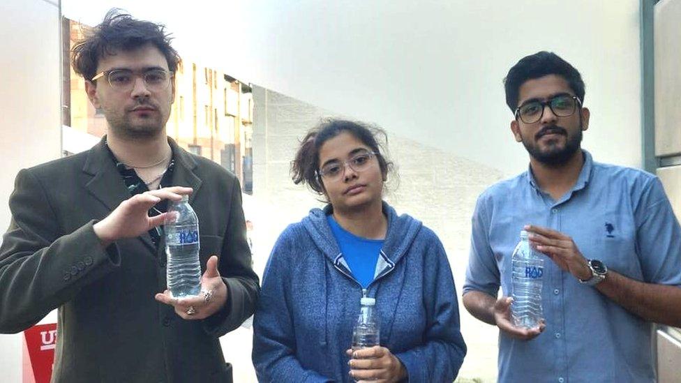 Oscar, Atrayee and Abuzarali with bottled water