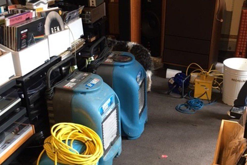 Blow-dryers are being used to dry the flooded carpets