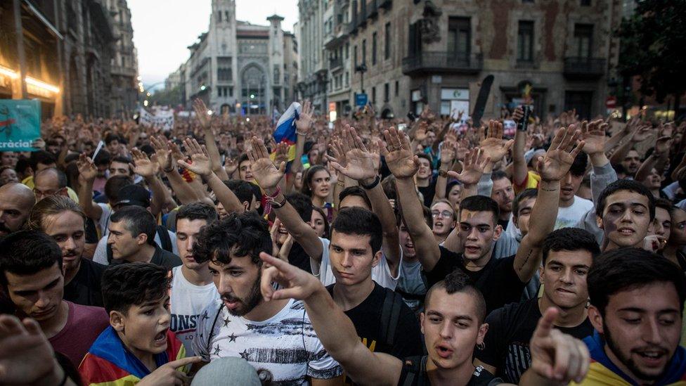 Thousands of people gather outside the national police building in Barcelona to protest against violence that marred the referendum. 3 October 2017