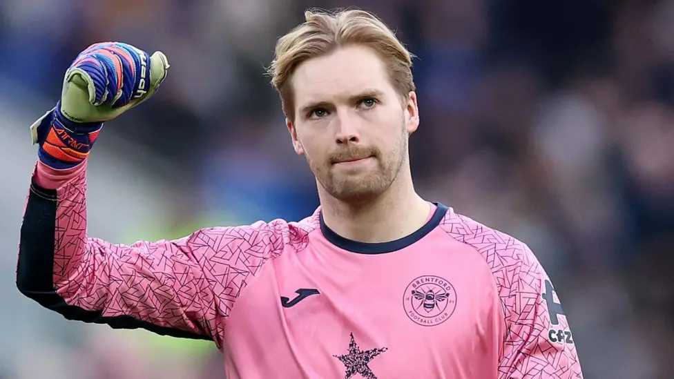 Brentford goalkeeper Caoimhin Kelleher salutes fans during a Premier League match 