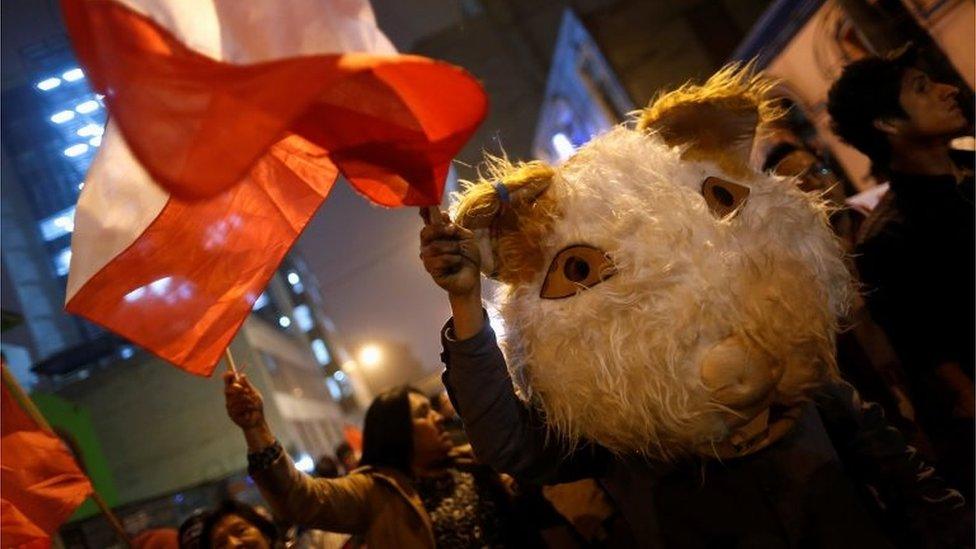 Supporters of Peruvian presidential candidate Pedro Pablo Kuczynski holding stand outside Peru"s National Office of Electoral Processes (ONPE) in Lima, Peru, June 7, 2016