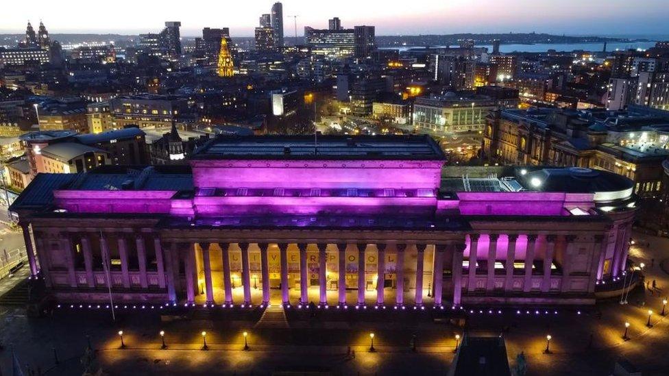 An aerial photo of St George's Hall illuminated in purple