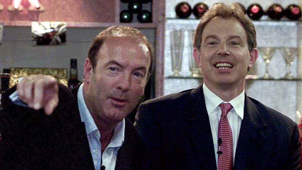 Britain's Prime Minister Tony Blair (R) attends a question and answer session with host Dean Sullivan, who plays Jimmy Corkhill in the Channel 4 soap opera Brookside, on the set of Bev's Bar while on a visit to Liverpool June 1, 2001.