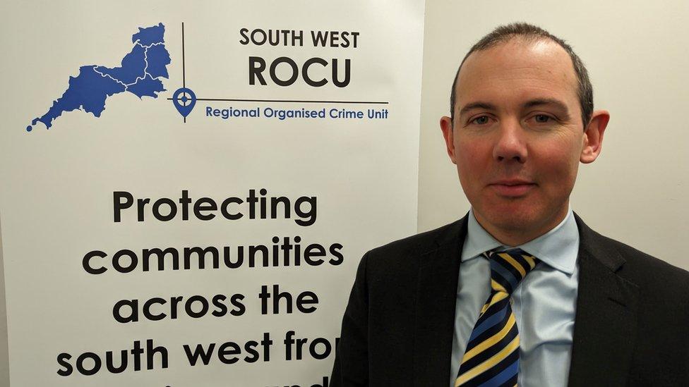 DCI Fisher standing in front of a banner that says "protecting communities across the South west"