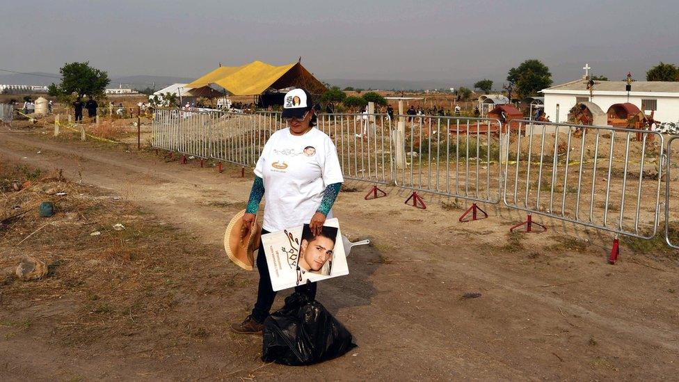 The relative of a missing person waits for the exhumation of 116 bodies found in a mass grave at Tetelcingo community in Morelos State, Mexico on May 23, 2016.