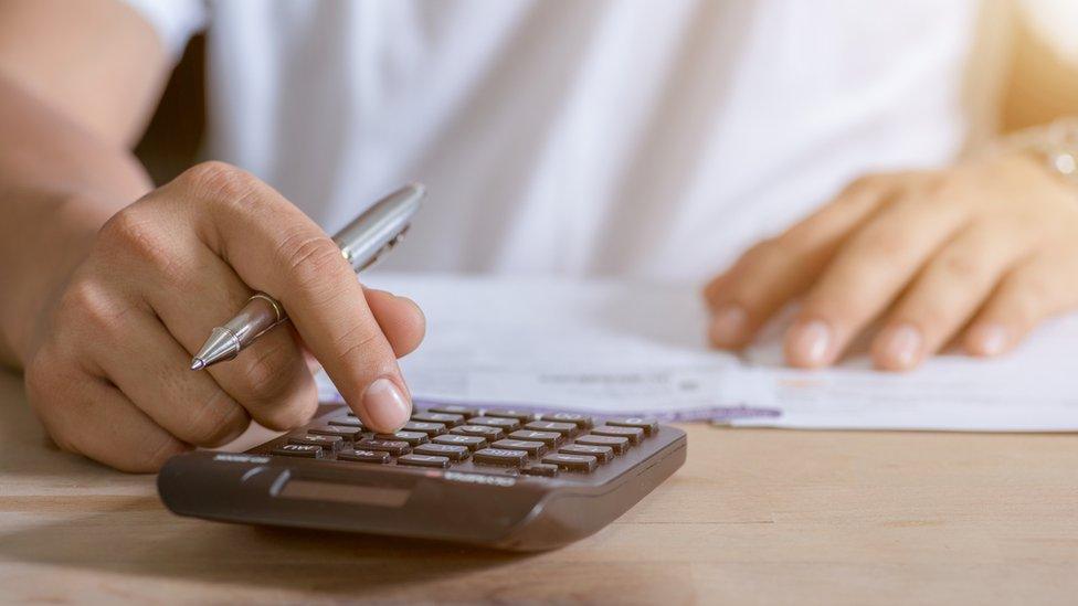 Woman using calculator