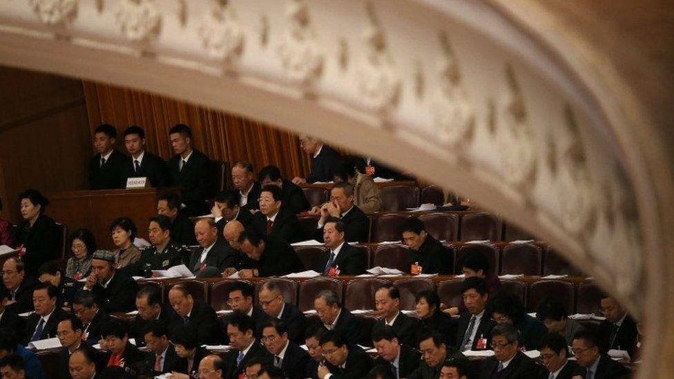 Delegates and security officers in the hall during the fourth session of China's 12th National People's Congress (NPC) at the Great Hall of the People in Beijing (13 March 2016)