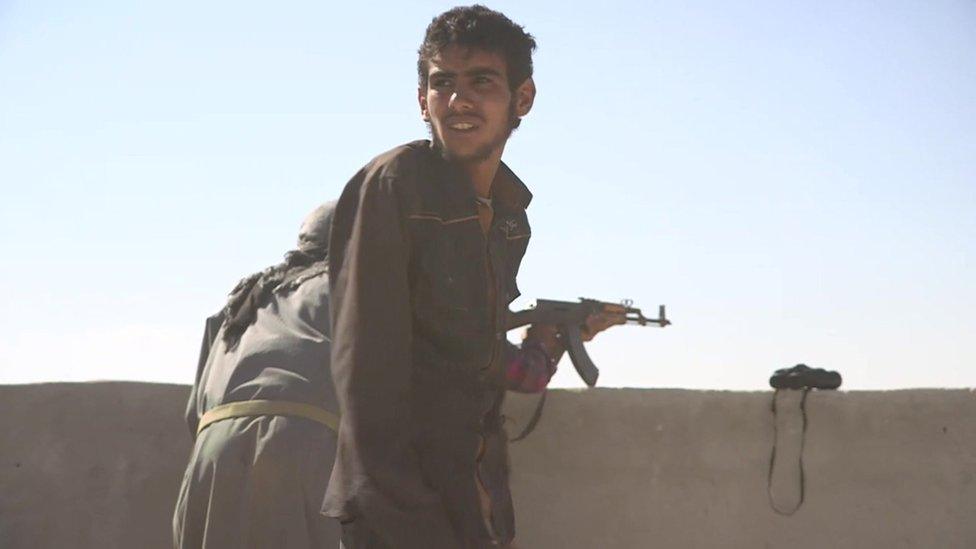 Arab fighter on watch on a building overlooking Manbij